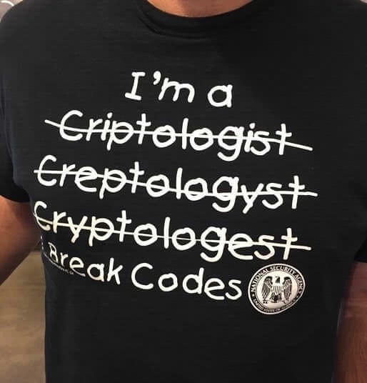 Funny t-shirt with Cryptologist misspelled and struck through three times, then changed to "I break codes."